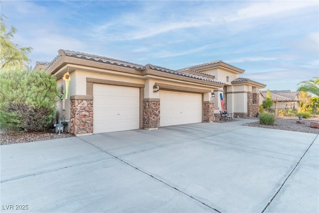 1239 N Hollywood Blvd, Las Vegas, NV 89110 - view of front of house with driveway, stone siding, an attached garage, stucco siding, and a tiled roof