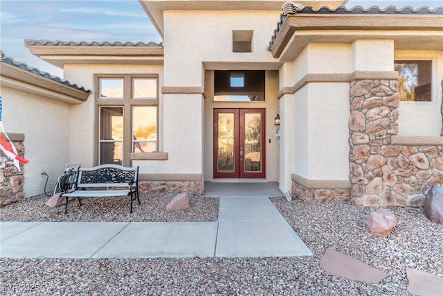 1239 N Hollywood Blvd, Las Vegas, NV 89110 - entrance to property with french doors, a tiled roof, stone siding, and stucco siding
