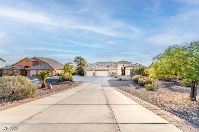 1239 N Hollywood Blvd, Las Vegas, NV 89110 - mediterranean / spanish home featuring concrete driveway and an attached garage