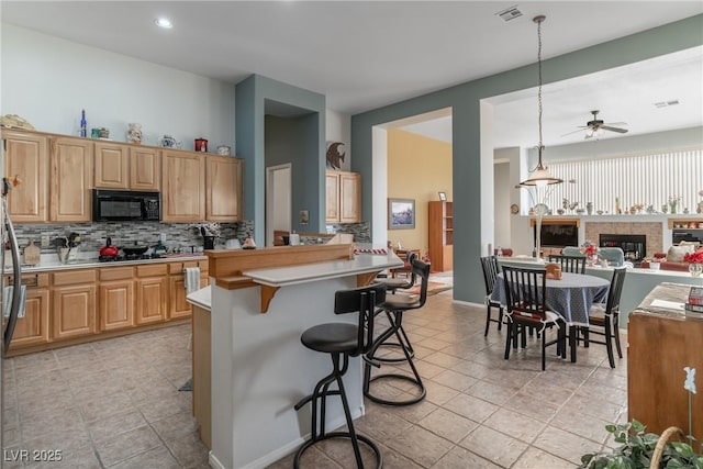 1239 N Hollywood Blvd, Las Vegas, NV 89110 - kitchen with black microwave, tasteful backsplash, a ceiling fan, light countertops, and recessed lighting