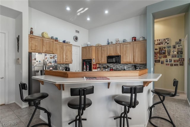 1239 N Hollywood Blvd, Las Vegas, NV 89110 - kitchen featuring black appliances, decorative backsplash, light tile patterned floors, light countertops, and recessed lighting