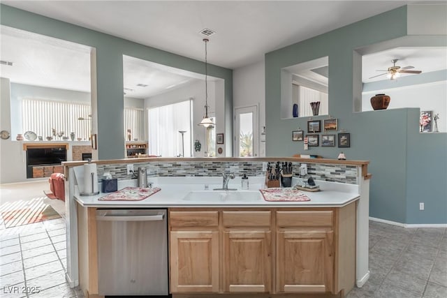 1239 N Hollywood Blvd, Las Vegas, NV 89110 - kitchen featuring dishwasher, backsplash, light tile patterned floors, and light countertops