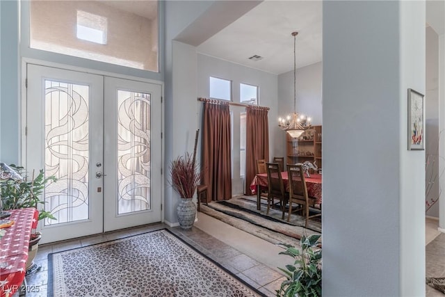 1239 N Hollywood Blvd, Las Vegas, NV 89110 - tiled entrance foyer with french doors and a chandelier