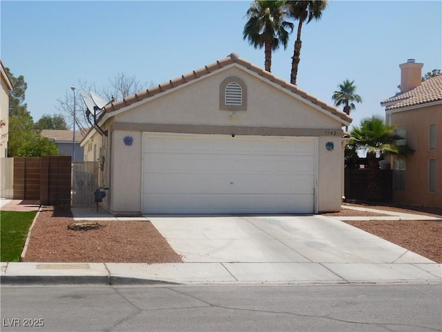7542 Mycroft Ct, Las Vegas, NV 89147 - view of front of home featuring concrete driveway, a garage, stucco siding, and a tile roof
