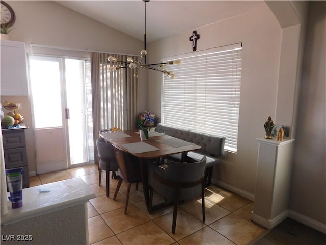 7542 Mycroft Ct, Las Vegas, NV 89147 - dining room featuring a chandelier, light tile patterned floors, lofted ceiling, and arched walkways