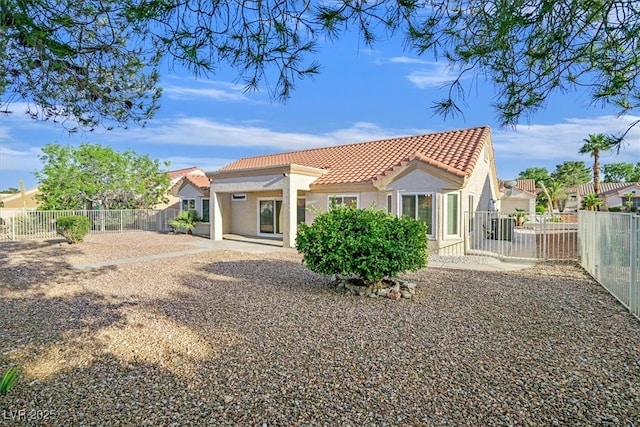 8924 Signal Terrace Dr, Las Vegas, NV 89134 - rear view of house featuring a tile roof, stucco siding, and a fenced backyard