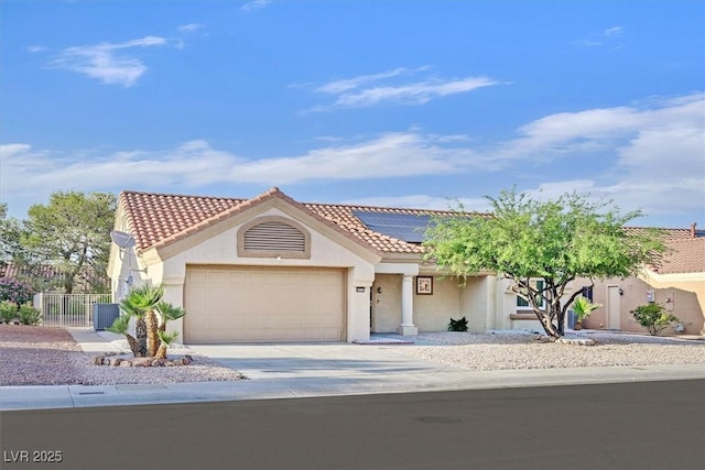 8924 Signal Terrace Dr, Las Vegas, NV 89134 - view of front of home with roof mounted solar panels, driveway, an attached garage, stucco siding, and a tile roof