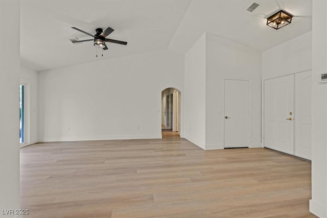 8924 Signal Terrace Dr, Las Vegas, NV 89134 - unfurnished living room featuring ceiling fan, arched walkways, light wood-style flooring, and lofted ceiling