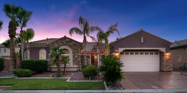 8209 Chapelle Ct, Las Vegas, NV 89131 - mediterranean / spanish-style home with driveway, a tile roof, stucco siding, and an attached garage