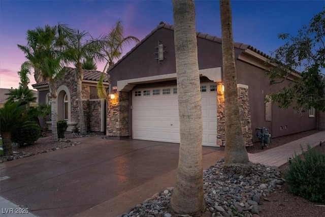 8209 Chapelle Ct, Las Vegas, NV 89131 - view of front of house featuring concrete driveway, stucco siding, a tiled roof, an attached garage, and stone siding