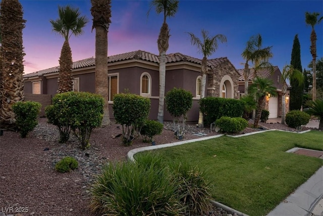 8209 Chapelle Ct, Las Vegas, NV 89131 - mediterranean / spanish-style home featuring stucco siding, a front yard, a tiled roof, and stone siding