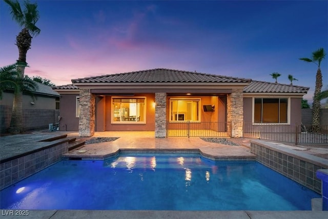 8209 Chapelle Ct, Las Vegas, NV 89131 - rear view of property with stone siding, a tiled roof, stucco siding, and a patio area