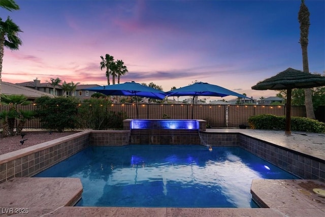 8209 Chapelle Ct, Las Vegas, NV 89131 - pool at dusk featuring a fenced backyard and a pool with connected hot tub