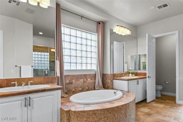 8209 Chapelle Ct, Las Vegas, NV 89131 - bathroom featuring two vanities and a bath
