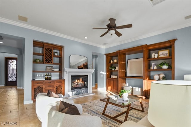 8209 Chapelle Ct, Las Vegas, NV 89131 - living room featuring a ceiling fan, ornamental molding, a glass covered fireplace, light tile patterned flooring, and recessed lighting