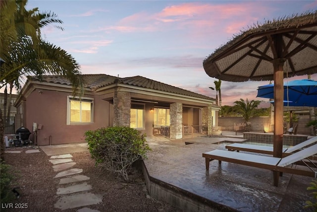 8209 Chapelle Ct, Las Vegas, NV 89131 - rear view of property with stone siding, a tiled roof, stucco siding, and a patio