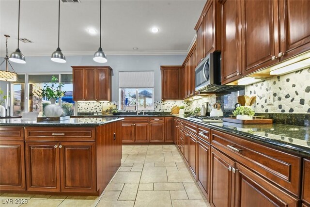 8209 Chapelle Ct, Las Vegas, NV 89131 - kitchen featuring stainless steel appliances, backsplash, hanging light fixtures, ornamental molding, and dark stone countertops