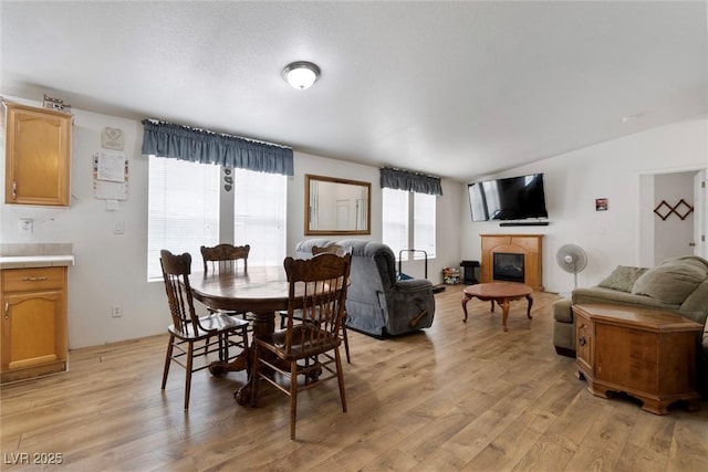 6337 W Cactus Ave, Las Vegas, NV 89141 - dining area featuring light wood finished floors and a glass covered fireplace
