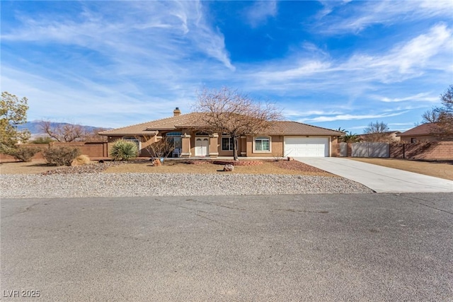 6781 Southgate St, Pahrump, NV 89061 - view of front facade with concrete driveway, an attached garage, covered porch, a chimney, and stucco siding