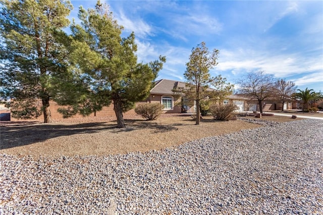 6781 Southgate St, Pahrump, NV 89061 - obstructed view of property featuring stucco siding