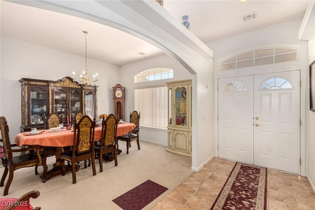 6781 Southgate St, Pahrump, NV 89061 - foyer entrance with arched walkways, a chandelier, and light colored carpet