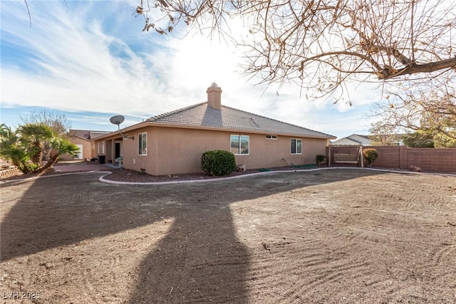 6781 Southgate St, Pahrump, NV 89061 - back of house with a chimney and stucco siding