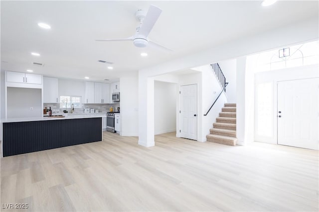 5264 Silverheart Ave, Las Vegas, NV 89142 - kitchen featuring appliances with stainless steel finishes, white cabinetry, recessed lighting, light countertops, and light wood-style flooring