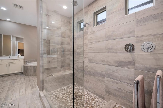 10349 Bressana Dr, Las Vegas, NV 89135 - bathroom with a tile shower, vanity, a bath, and recessed lighting