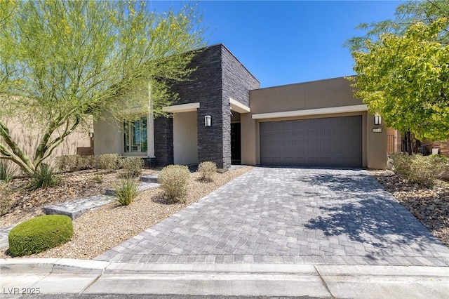 10349 Bressana Dr, Las Vegas, NV 89135 - view of front facade featuring stucco siding, an attached garage, and decorative driveway