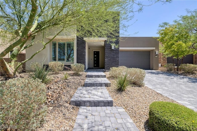 10349 Bressana Dr, Las Vegas, NV 89135 - view of front of home with stucco siding, a garage, and decorative driveway