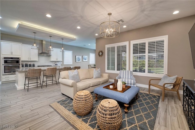 10349 Bressana Dr, Las Vegas, NV 89135 - living room with light wood-type flooring, a chandelier, and recessed lighting
