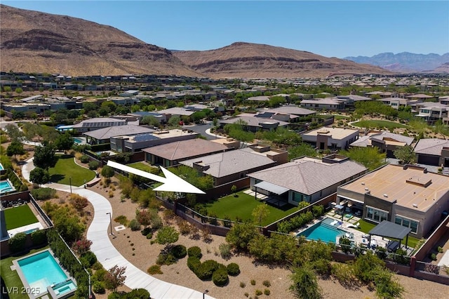 10349 Bressana Dr, Las Vegas, NV 89135 - aerial perspective of suburban area featuring a pool area and a mountainous background