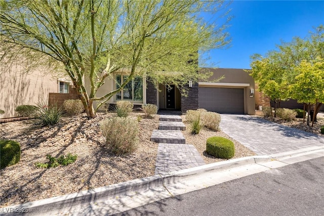 10349 Bressana Dr, Las Vegas, NV 89135 - view of front facade with stucco siding, a garage, and decorative driveway