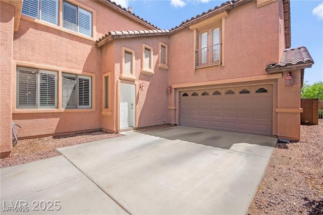 11274 Civita St, Las Vegas, NV 89141 - view of front of home with a tile roof, a garage, driveway, and stucco siding