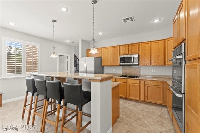 11274 Civita St, Las Vegas, NV 89141 - kitchen featuring stainless steel appliances, a kitchen island, a kitchen bar, recessed lighting, and hanging light fixtures