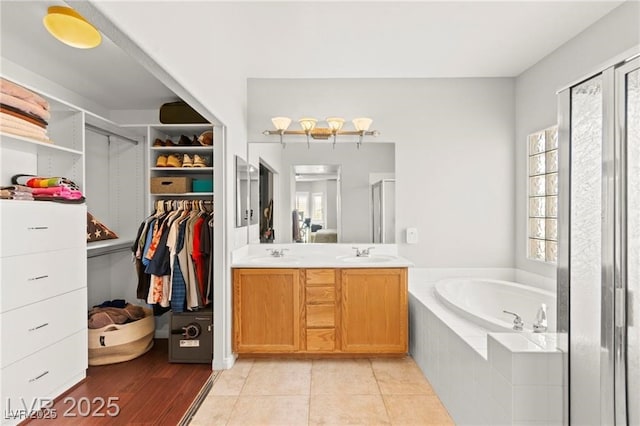 11274 Civita St, Las Vegas, NV 89141 - bathroom with a bath, a shower stall, double vanity, and a walk in closet