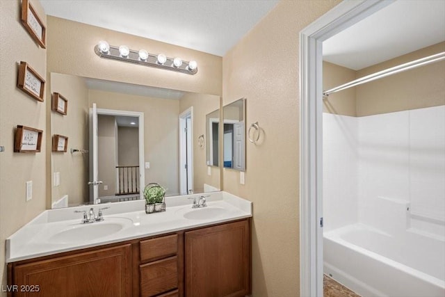 7028 Weavers Pl, North Las Vegas, NV 89084 - bathroom with double vanity, shower / bath combination, and a textured wall