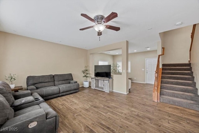 7028 Weavers Pl, North Las Vegas, NV 89084 - living room with a ceiling fan, wood finished floors, and stairs