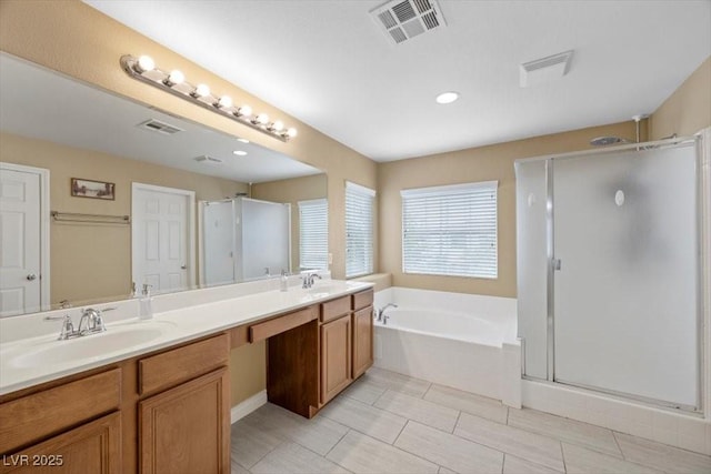7028 Weavers Pl, North Las Vegas, NV 89084 - bathroom featuring a shower stall, a garden tub, and double vanity