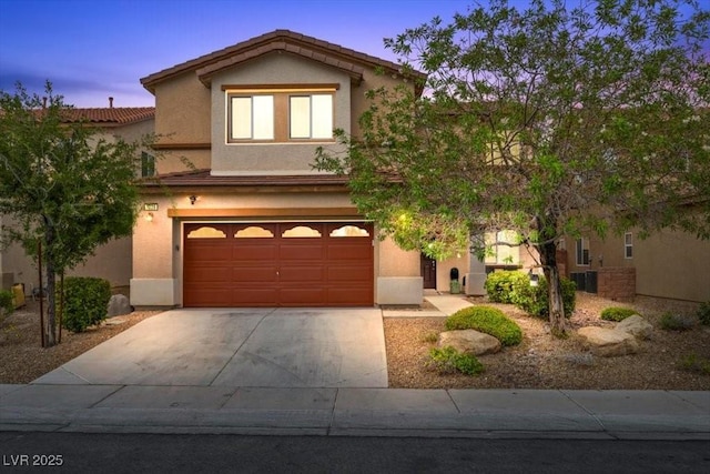 7028 Weavers Pl, North Las Vegas, NV 89084 - view of front of home featuring a garage, driveway, and stucco siding