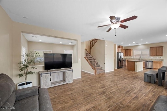 7028 Weavers Pl, North Las Vegas, NV 89084 - living room with stairway, a ceiling fan, wood finished floors, and recessed lighting