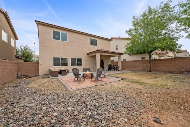 7028 Weavers Pl, North Las Vegas, NV 89084 - back of house with a fire pit, a fenced backyard, a patio area, and stucco siding