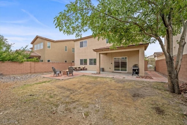 7028 Weavers Pl, North Las Vegas, NV 89084 - back of property featuring stucco siding, a fenced backyard, and a patio