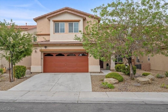 7028 Weavers Pl, North Las Vegas, NV 89084 - view of front of house featuring a garage, driveway, and stucco siding