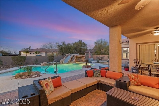 7670 Frittata Ave, Las Vegas, NV 89113 - view of swimming pool with a water slide, an outdoor hangout area, a fenced backyard, ceiling fan, and a patio area