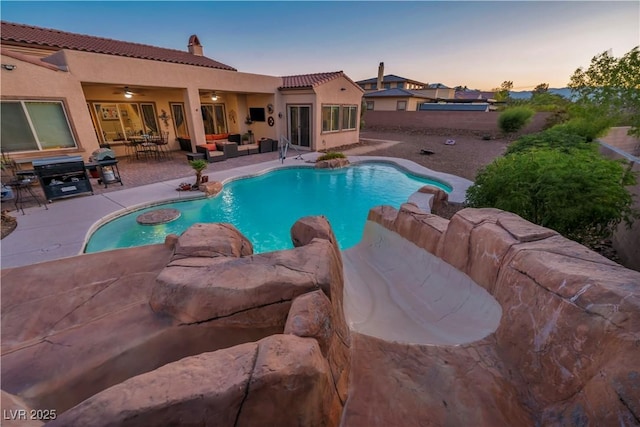 7670 Frittata Ave, Las Vegas, NV 89113 - pool at dusk featuring outdoor lounge area, an outdoor pool, a ceiling fan, and a patio