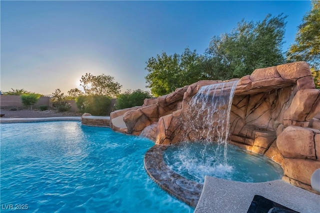 7670 Frittata Ave, Las Vegas, NV 89113 - pool at dusk featuring a pool with connected hot tub