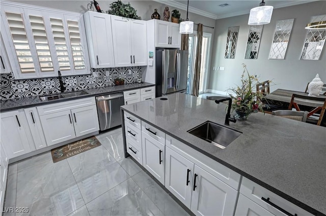 2891 S Rainbow Ave, Pahrump, NV 89048 - kitchen with stainless steel appliances, crown molding, light marble finish floors, tasteful backsplash, and pendant lighting