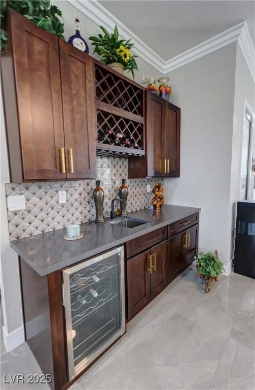 2891 S Rainbow Ave, Pahrump, NV 89048 - indoor bar with crown molding, beverage cooler, and backsplash