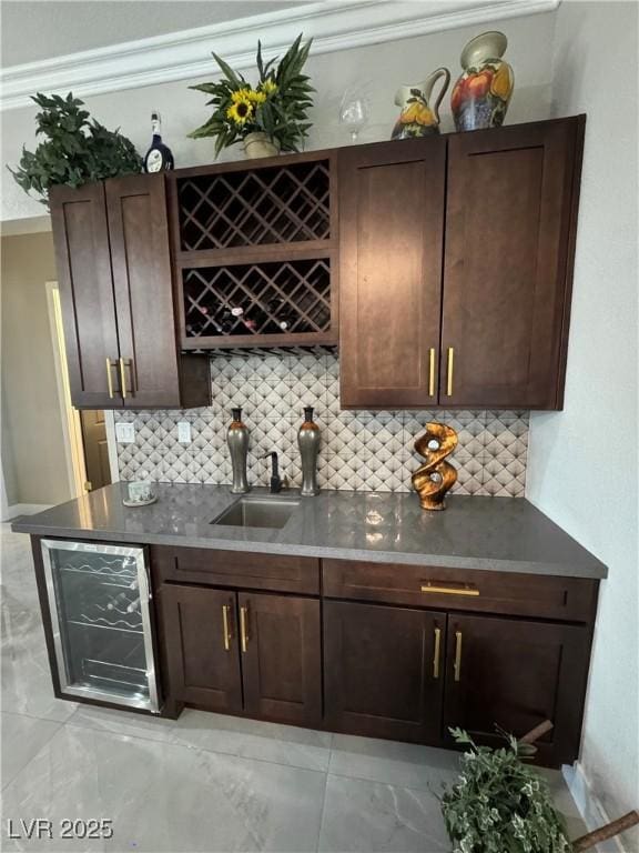 2891 S Rainbow Ave, Pahrump, NV 89048 - indoor wet bar featuring beverage cooler, backsplash, ornamental molding, and light marble finish flooring